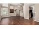 Spacious living room with high ceilings, wood floors, and staircase with white railings at 21614 N 59Th Ln, Glendale, AZ 85308