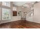 Elegant living room boasting hardwood floors, plantation shutters, and a dramatic staircase creating a welcoming atmosphere at 21614 N 59Th Ln, Glendale, AZ 85308