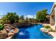 Beautiful pool with stone accents and landscaping providing a tranquil backyard retreat at 21614 N 59Th Ln, Glendale, AZ 85308