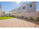 Well-kept backyard with stone pavers, a small lawn, and lush landscaping, perfect for outdoor enjoyment at 2195 N Peden Dr, Chandler, AZ 85225