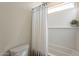 Bathroom featuring a shower with a white curtain, tile and a small window at 2195 N Peden Dr, Chandler, AZ 85225