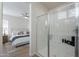Modern bathroom with tiled shower, glass door, and a glimpse of a comfortable bedroom at 2195 N Peden Dr, Chandler, AZ 85225