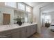 Bathroom featuring a wide mirror and double sinks with lots of natural light and hardwood floors at 2195 N Peden Dr, Chandler, AZ 85225