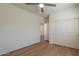 Bedroom featuring light hardwood floors, a ceiling fan, and a closet at 2195 N Peden Dr, Chandler, AZ 85225