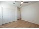 Bedroom featuring light hardwood floors, a ceiling fan, and a closet at 2195 N Peden Dr, Chandler, AZ 85225
