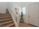 Bright hallway features wooden stairs, white trim, wood floors, and neutral decor for a clean and modern look at 2195 N Peden Dr, Chandler, AZ 85225