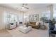 Bright living room with modern ceiling fan, comfortable seating, large windows, and stylish decor creates inviting space at 2195 N Peden Dr, Chandler, AZ 85225