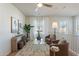 Bright and airy loft area with a ceiling fan, featuring two armchairs and a glass table at 2195 N Peden Dr, Chandler, AZ 85225