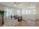 Bright loft area featuring hardwood floors, two armchairs and a ceiling fan with white walls and a window at 2195 N Peden Dr, Chandler, AZ 85225