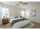 Bright main bedroom with a ceiling fan, windows with white curtains and hardwood floors at 2195 N Peden Dr, Chandler, AZ 85225