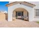 Covered patio with brick pavers, inviting seating, and elegant arches, perfect for relaxation and entertaining at 2195 N Peden Dr, Chandler, AZ 85225