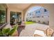 Inviting covered patio with stone pavers, outdoor seating, and manicured lawn for relaxing or entertaining at 2195 N Peden Dr, Chandler, AZ 85225
