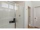 Modern walk-in shower with glass doors and white subway tile throughout with natural light at 2195 N Peden Dr, Chandler, AZ 85225