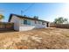 Spacious backyard showing the exterior of the home with a textured stucco finish and a concrete patio at 2242 W Pecan Rd, Phoenix, AZ 85041