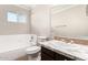 This bathroom features a vanity, framed mirror, toilet, and a shower-tub combo with a window at 2242 W Pecan Rd, Phoenix, AZ 85041