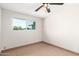 This light and airy bedroom is complete with tile flooring, a ceiling fan, and a neighborhood-view window at 2242 W Pecan Rd, Phoenix, AZ 85041