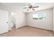 Bedroom with tile floors, closet, ceiling fan, and a window with backyard view at 2242 W Pecan Rd, Phoenix, AZ 85041