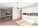 Open dining area with tile flooring, modern chandelier, and bar seating by the kitchen at 2242 W Pecan Rd, Phoenix, AZ 85041