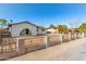 Exterior view of home showcasing its secure fencing and low maintenance yard at 2242 W Pecan Rd, Phoenix, AZ 85041