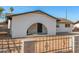 Close-up of house exterior featuring unique archway entryway and secure fencing at 2242 W Pecan Rd, Phoenix, AZ 85041