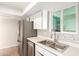 Kitchen with stainless steel refrigerator and sink with view of the countertop at 2242 W Pecan Rd, Phoenix, AZ 85041