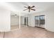 Bright living room featuring tile floors, mirrored closet doors, and a ceiling fan with light fixture at 2242 W Pecan Rd, Phoenix, AZ 85041