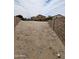 Large backyard surrounded by block fencing, offering privacy and potential for customization at 22872 W Gardenia Dr, Buckeye, AZ 85326