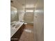 Well-maintained bathroom with a tub and shower combination, tile floors, and vanity with storage at 22872 W Gardenia Dr, Buckeye, AZ 85326