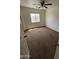 Cozy bedroom with neutral carpeting, ceiling fan, a window providing natural light, and closet space at 22872 W Gardenia Dr, Buckeye, AZ 85326
