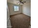 This bedroom offers cozy carpet, natural light and a ceiling fan at 22872 W Gardenia Dr, Buckeye, AZ 85326