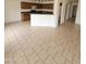 Open-concept kitchen and dining area featuring tile floors, a breakfast bar, and views of living room at 22872 W Gardenia Dr, Buckeye, AZ 85326