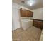 Functional laundry room featuring tile floors and built-in cabinets at 22872 W Gardenia Dr, Buckeye, AZ 85326