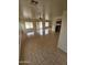Bright living room with tile floors, ceiling fan, and sliding glass doors to the backyard at 22872 W Gardenia Dr, Buckeye, AZ 85326