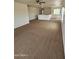 Upstairs living room with plush carpeting, neutral paint and ample sunlight from large window at 22872 W Gardenia Dr, Buckeye, AZ 85326