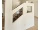 Hallway with open staircase providing a modern aesthetic and natural light at 22872 W Gardenia Dr, Buckeye, AZ 85326