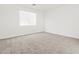 Bedroom featuring neutral carpet, a window with blinds, and white walls at 24486 W Grenadine Rd, Buckeye, AZ 85326