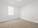 Neutral bedroom featuring carpeted floors and a window at 24486 W Grenadine Rd, Buckeye, AZ 85326