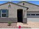 Charming single story home featuring a low maintenance rock yard, attached two car garage, and covered entryway at 24486 W Grenadine Rd, Buckeye, AZ 85326