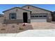 Charming single story home featuring a low maintenance rock yard, attached two car garage, and covered entryway at 24486 W Grenadine Rd, Buckeye, AZ 85326