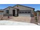 Charming single story home featuring a low maintenance rock yard, attached two car garage, and covered entryway at 24486 W Grenadine Rd, Buckeye, AZ 85326