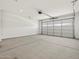 Spacious two car garage with white walls and concrete floor, perfect for storage and vehicles at 24486 W Grenadine Rd, Buckeye, AZ 85326