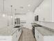 Kitchen featuring stainless steel appliances, white cabinets, granite countertops, and gray tile floor at 24486 W Grenadine Rd, Buckeye, AZ 85326