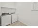 Picture of a laundry room with a washer, dryer, and shelving at 24486 W Grenadine Rd, Buckeye, AZ 85326