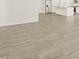 Bright living room featuring tile floors flowing into a kitchen area with stainless steel appliances at 24486 W Grenadine Rd, Buckeye, AZ 85326