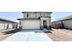 Two-story home featuring a two car garage and a modern entrance at 25130 N 156Th Ln, Surprise, AZ 85387