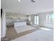 Spacious open-plan living room and kitchen area with tile flooring and lots of natural light at 25130 N 156Th Ln, Surprise, AZ 85387
