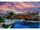 Beautiful backyard with pool, lush landscaping, and covered patio at dusk at 2731 W Desert Ranch Rd, Phoenix, AZ 85086