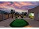 Wide backyard view of putting green, lush vegetation and desert sky at 2731 W Desert Ranch Rd, Phoenix, AZ 85086