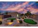 Backyard with multiple putting greens, desert landscaping, and sunset at 2731 W Desert Ranch Rd, Phoenix, AZ 85086