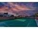 Backyard basketball court with putting green at dusk at 2731 W Desert Ranch Rd, Phoenix, AZ 85086